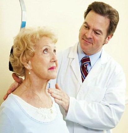 doctor treating an older female patient